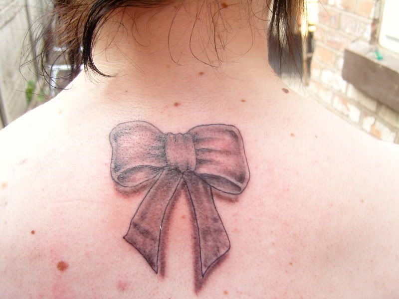 Bow tattoo on the Upper Back