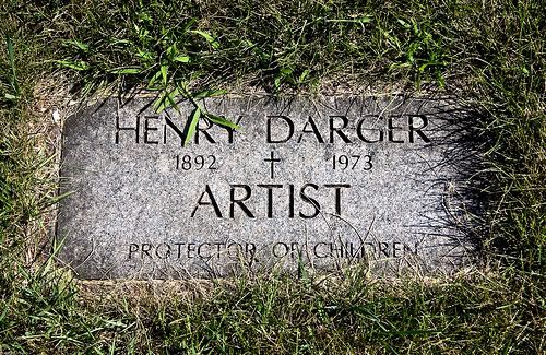 Picture of a flat gravestone with grass growing over it. It says: Henry Darger, 1892-1973, artist, protector of children.